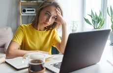 woman looking stressed at the computer