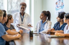 Teacher talks to students in medical program