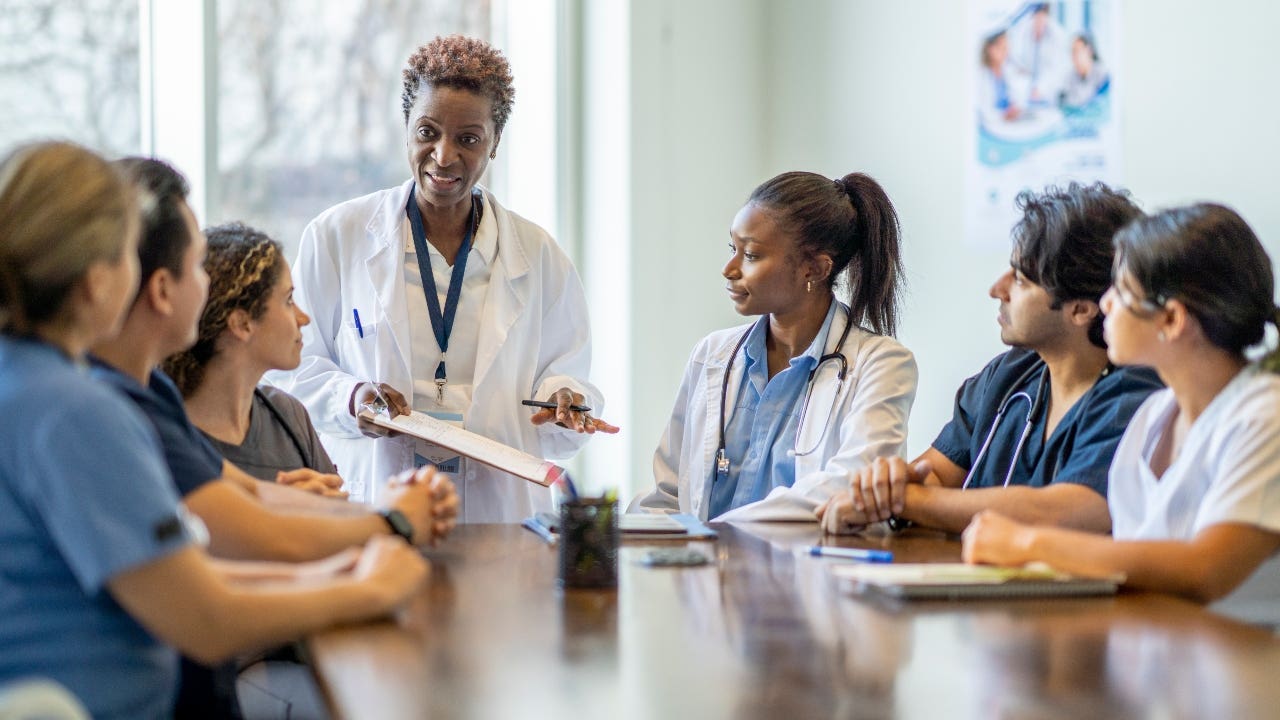 Teacher talks to students in medical program