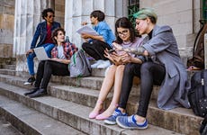 college students studying on some steps