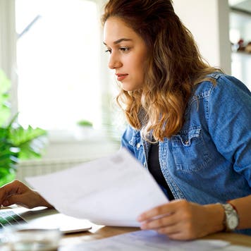 Serious young woman working at home