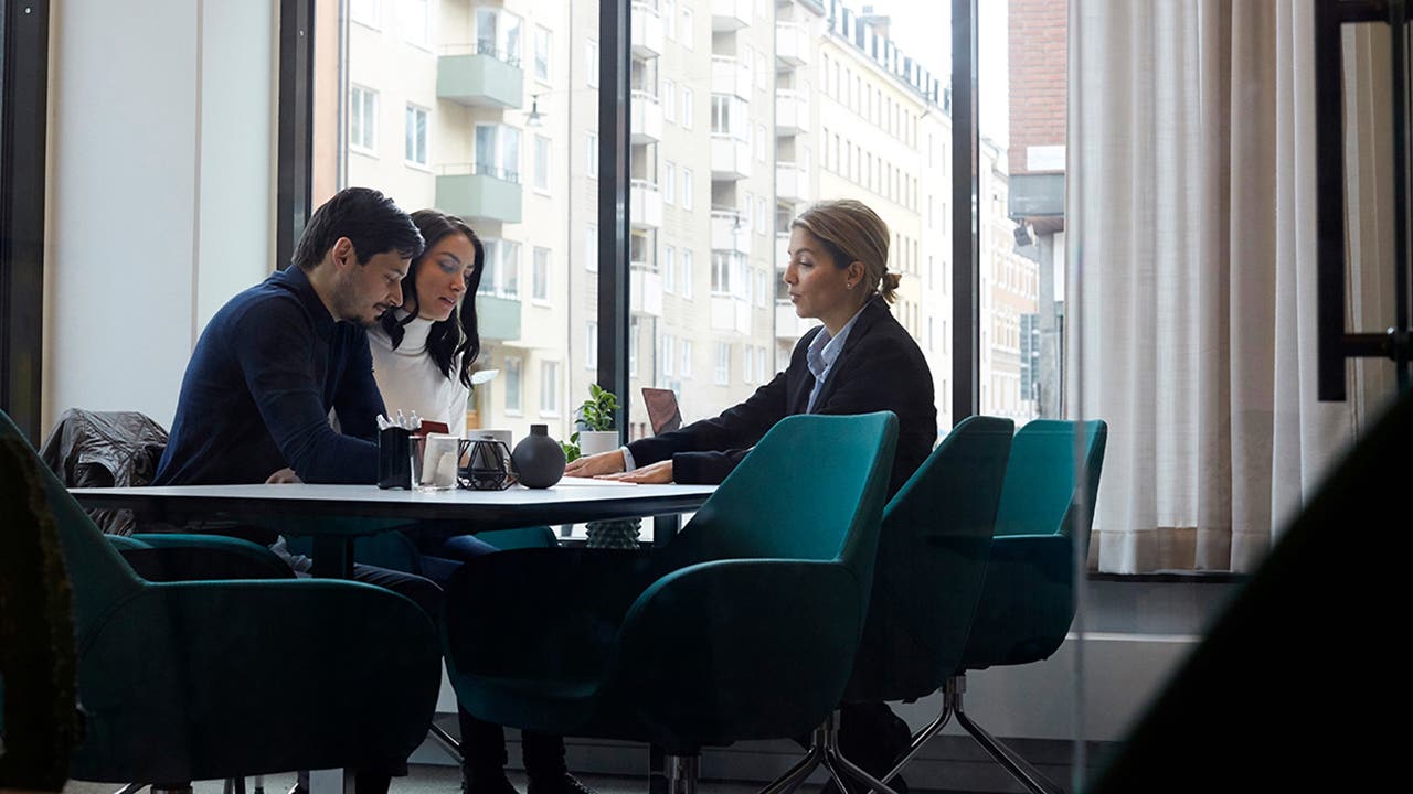 Real estate agent discussing with couple in office