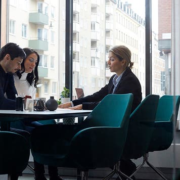 Real estate agent discussing with couple in office