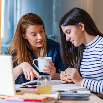 Mom helps daughter with homework