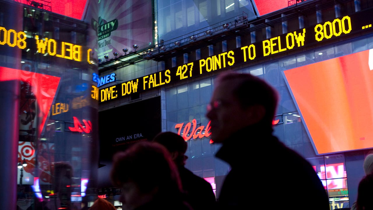 The Dow Jones ticker in Times Square displays news about the Dow closing below 8,000 at the end of the trading day in New York, U.S., on Wednesday, Nov. 19, 2008.