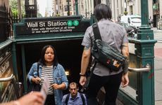 People walking out of the subway station at Wall Street