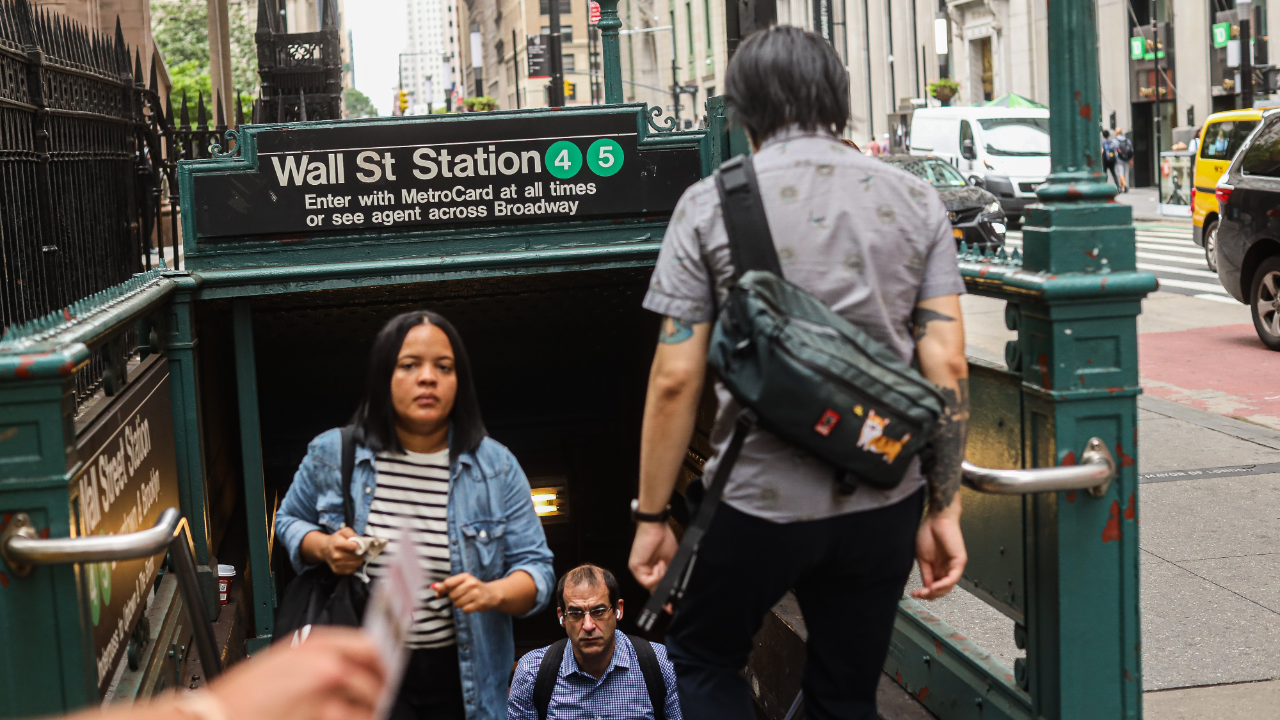 People walking out of the subway station at Wall Street