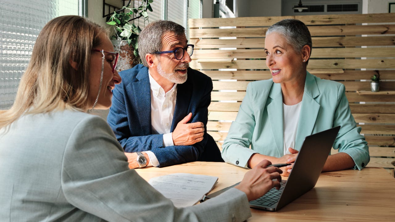 A financial advisor meets with a client couple