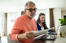 Senior couple payings bills inside home