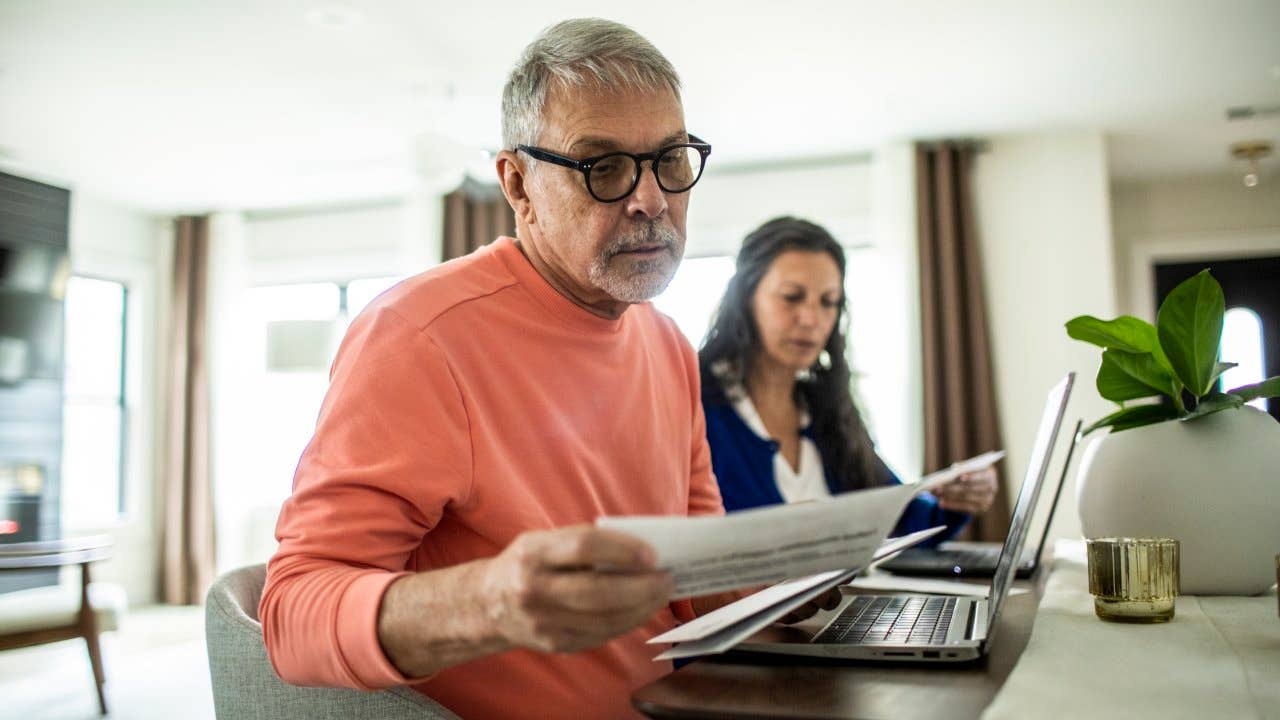 Senior couple payings bills inside home