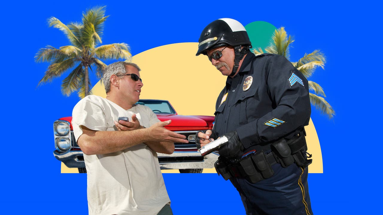 Cop writing a ticket to a driver standing outside their car