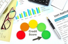 Credit score report with financial reports and loan application in the background
