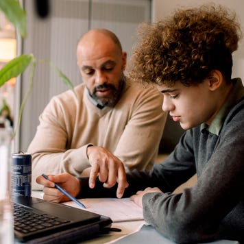 Father helps son with homework