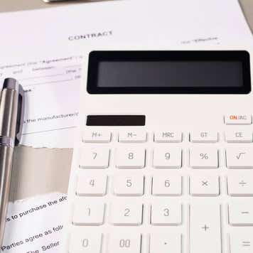 Torn contract and calculator for calculation losses.