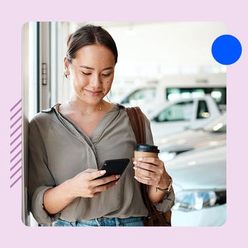 A woman uses her phone while standing in front of a car. The image is on a pink background.