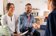 man shaking hands with financial advisor at home