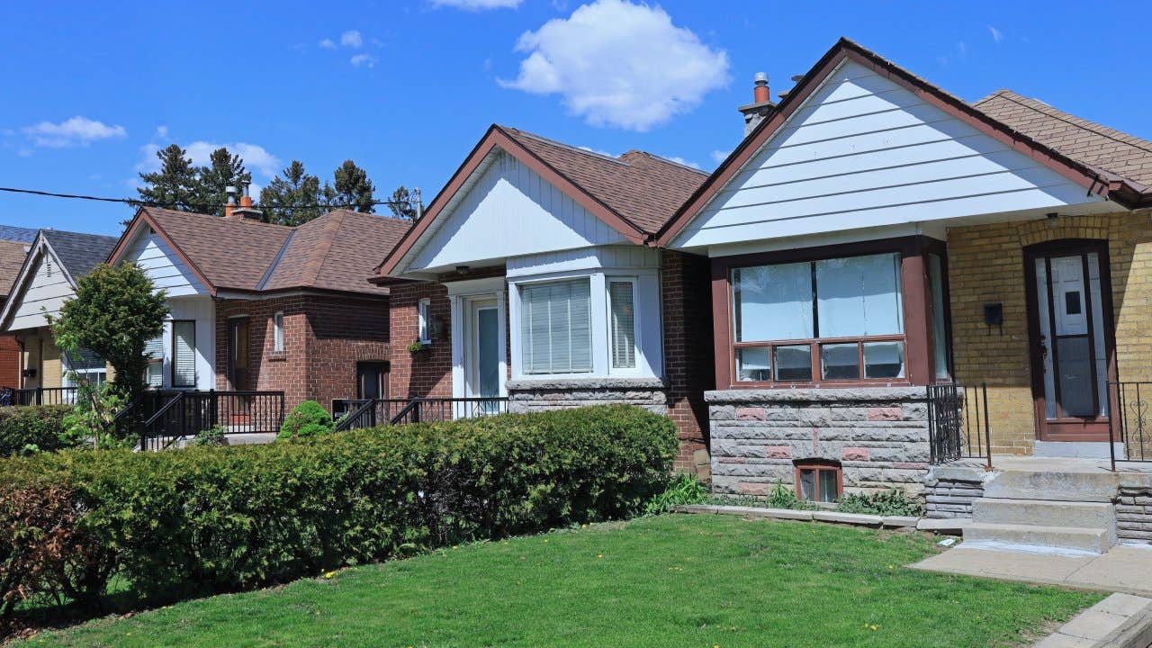 Row of small brick bungalow houses with gables