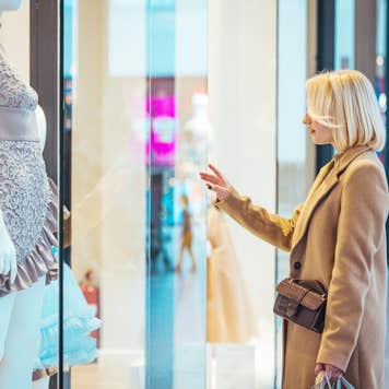 Photo of happy young woman on a shopping pursuit.