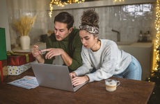 Young couple managing expenses and bills at home after holidays.