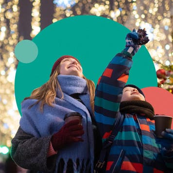 Mother and child looking at outdoor holiday decorations