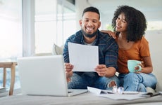 Young couple happily looking at financial documents