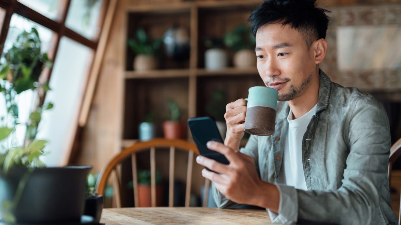 young man doing online banking with his phone