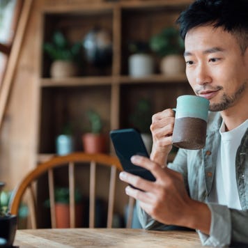 young man doing online banking with his phone