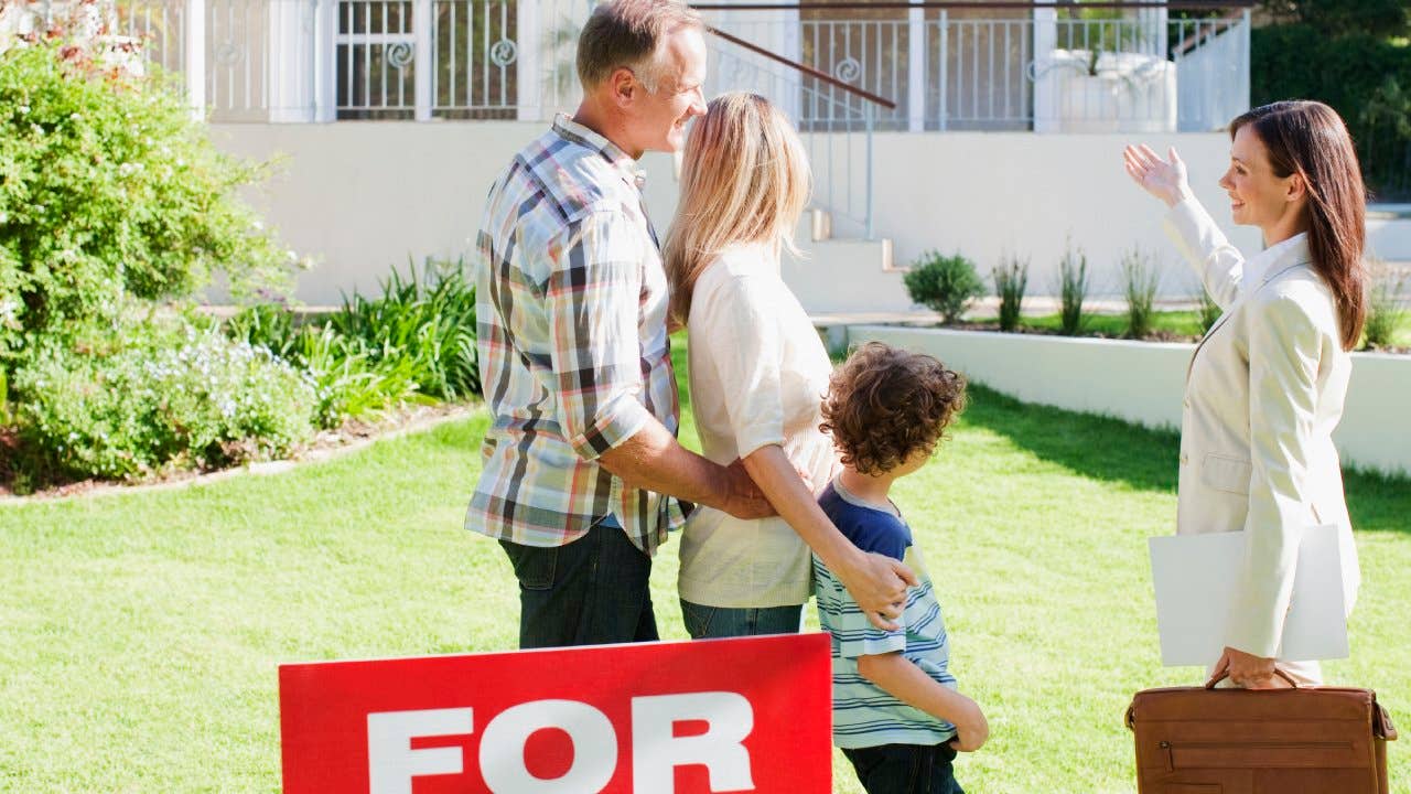 Real Estate Agent showing family a house for sale