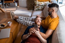 Two married men sit on the couch together