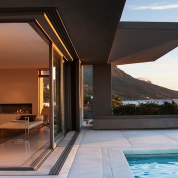 Modern living room and patio next to swimming pool