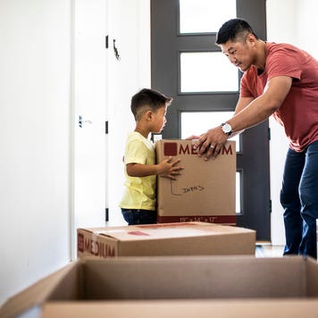 moving expenses - father and son packing moving boxes together