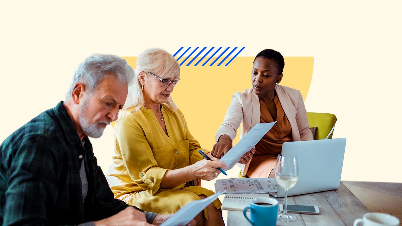 A married couple goes over some insurance documentation with a representative. There is a solid color graphical display added to the background.