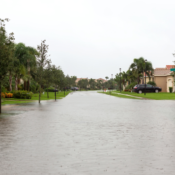 View of flooding from a hurricane or tropical storm with water filling the streets and cars in their driveways