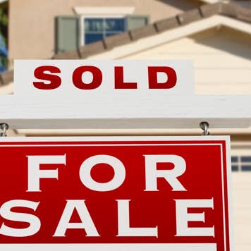 "For Sale" sign with a "SOLD" attached