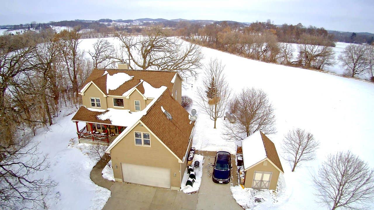 A house in the Wisconsin countryside covered in snow.
