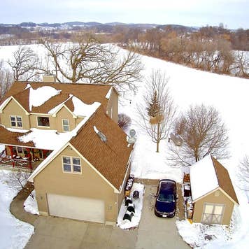 A house in the Wisconsin countryside covered in snow.