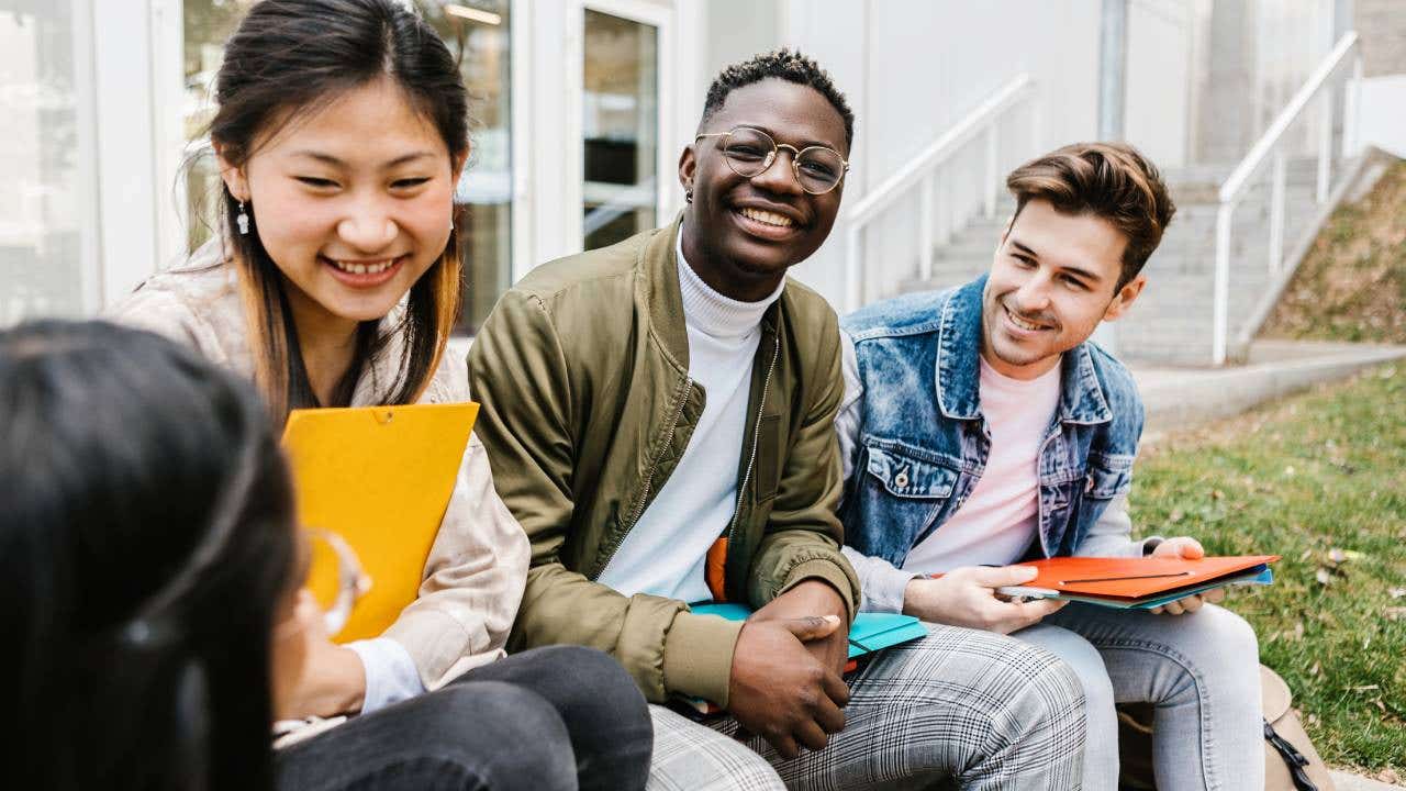 Multiracial group of young teenage people hanging out at university campus