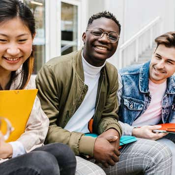 Multiracial group of young teenage people hanging out at university campus