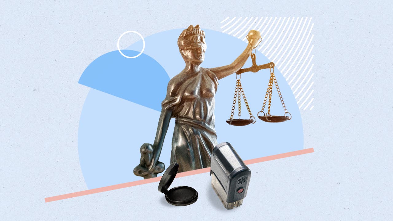 Image of statue holding scales and notary tools