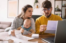 Young family with baby worried about family budget and high taxes and bills.
