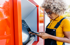 BIPOC woman using ATM