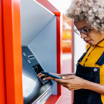 BIPOC woman using ATM
