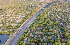 condemnation - aerial view of highway running through residential area