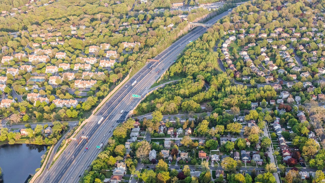 condemnation - aerial view of highway running through residential area