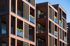 gross rent - apartment building exterior with wood detail and balconies
