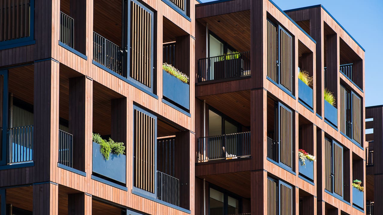 gross rent - apartment building exterior with wood detail and balconies