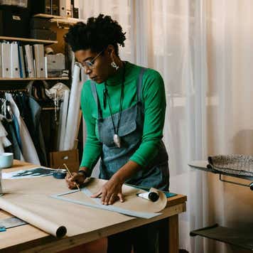 Woman doing craft at table in living room