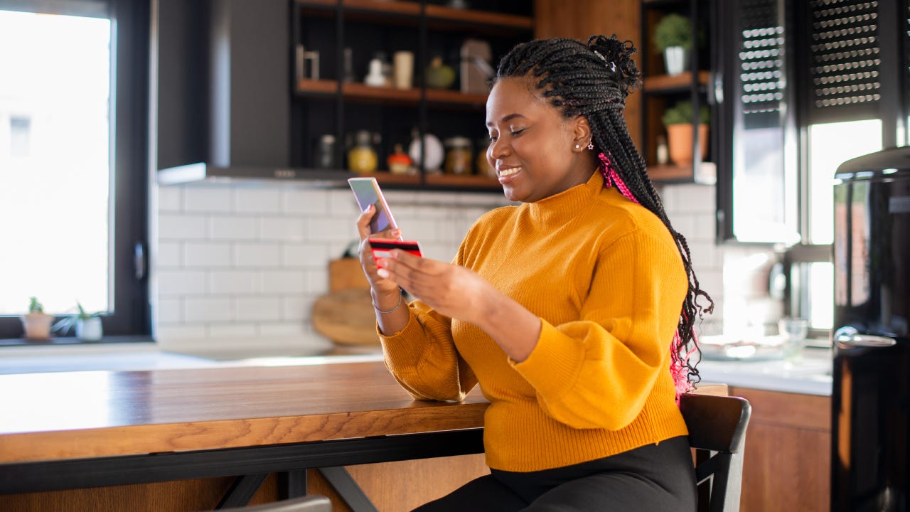 Woman using her credit card to shop online