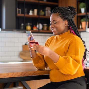 Woman using her credit card to shop online