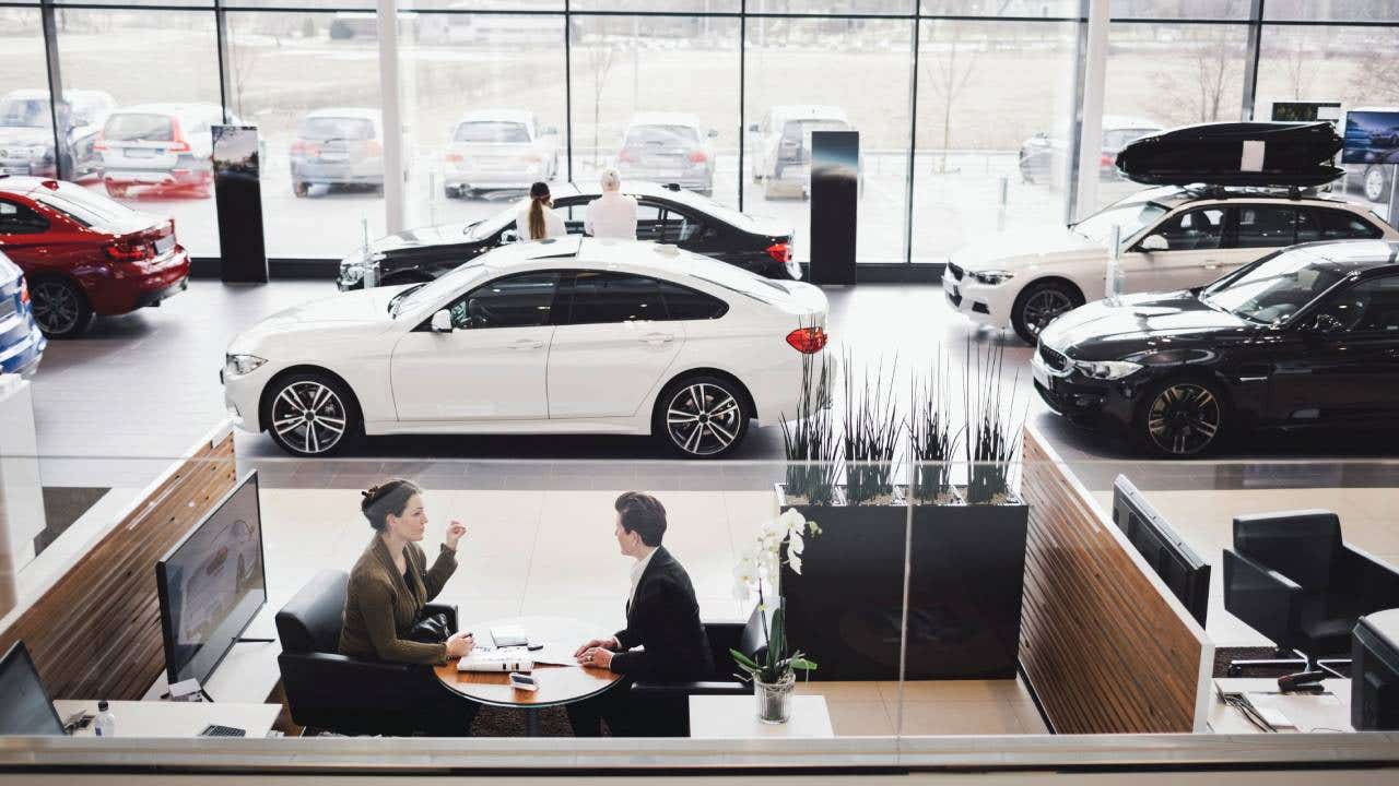 High angle view of saleswoman and customer discussing in meeting at showroom